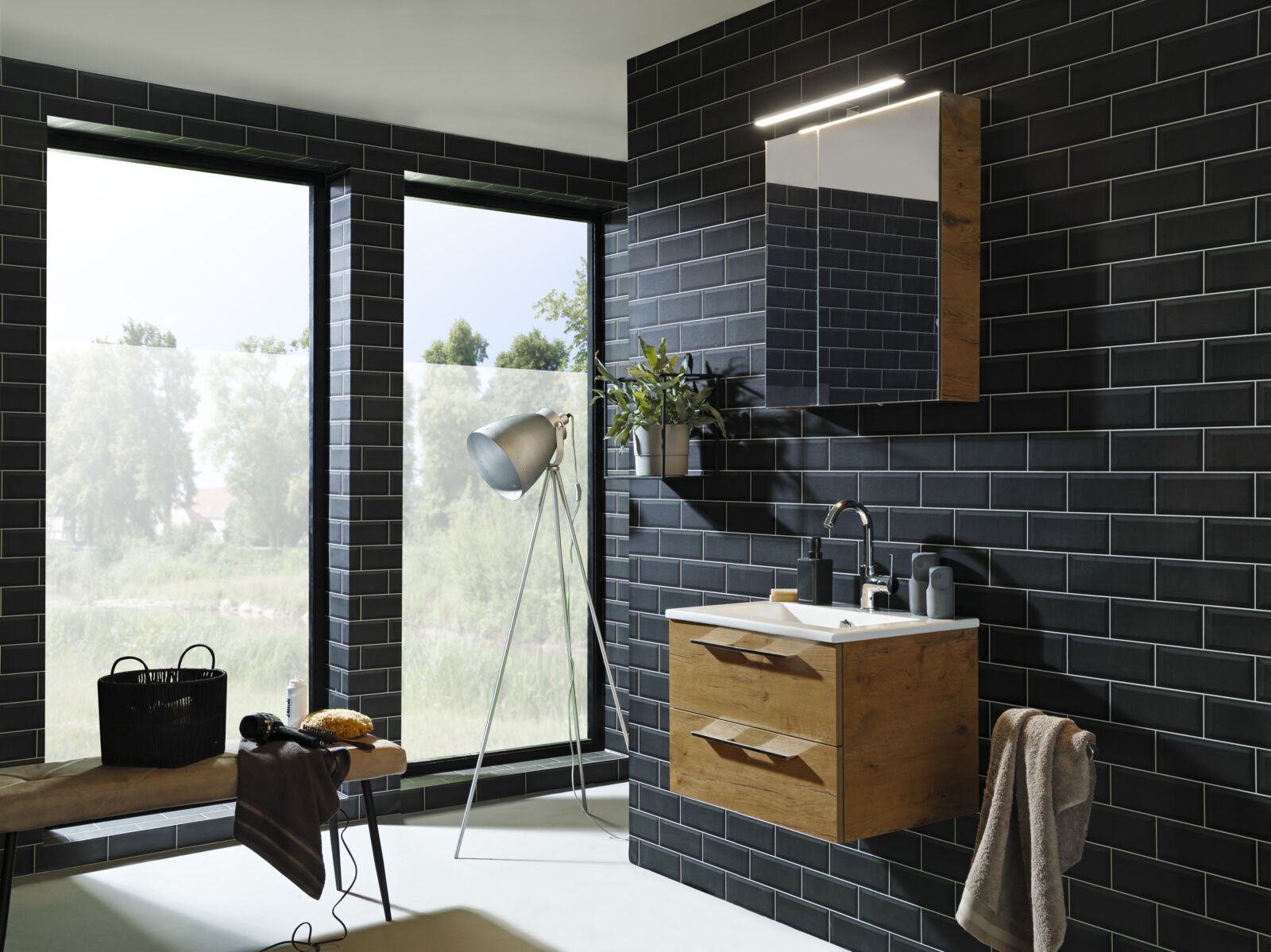 Blauwe metro tegels met een stijlvol gecombineerde houten look op het wasmeubel.